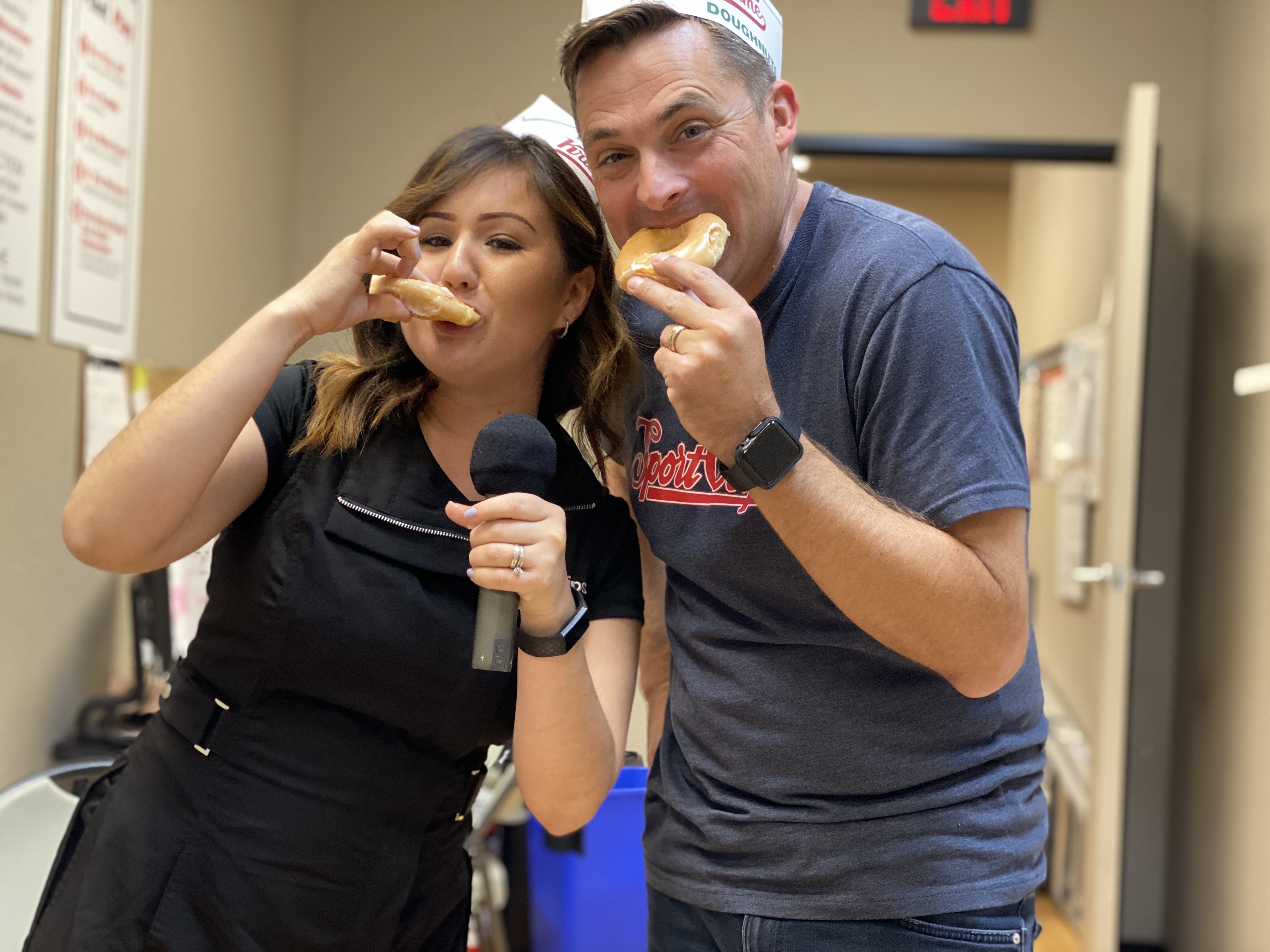 Chad Jordan and Laura Torres eating Krispy Kreme Donuts